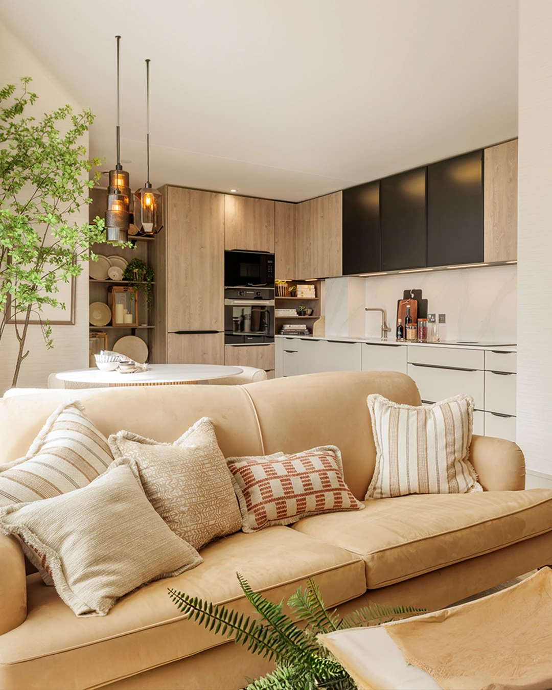 Modern kitchen and living area with beige sofa and wood accents in a Dublin home. Cosy and stylish interior design.